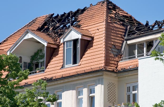 Residential home affected by fire damage captured in the image.