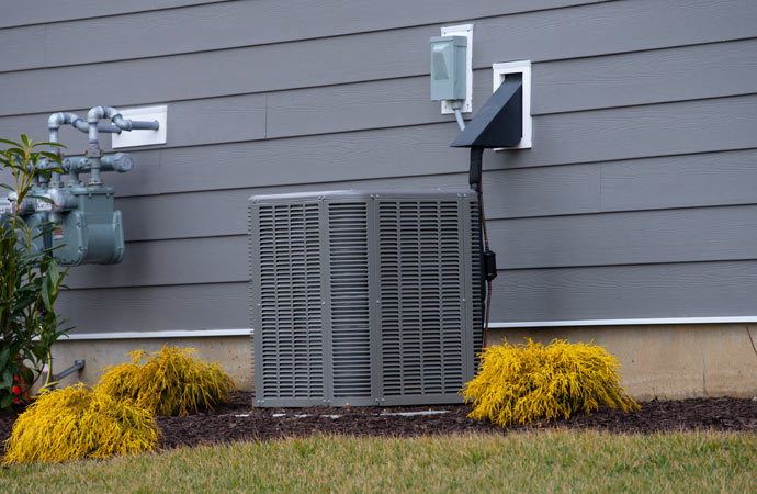 Air conditioner near the house with a cold fan, installed for cooling and air supply.