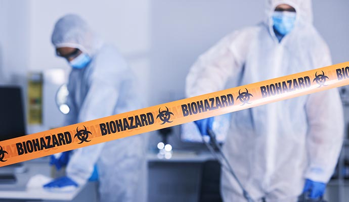 Professionals performing biohazard cleanup in a sealed and restricted area