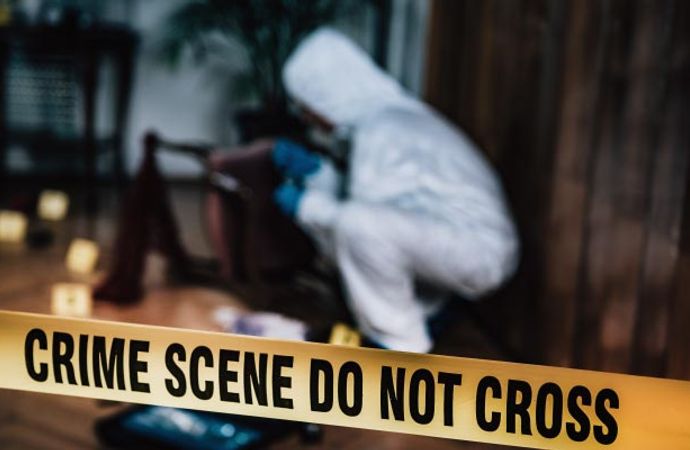 Crime scene cleanup team securing area during biohazard investigation