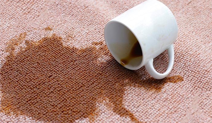 Residential carpet with a dark stain from spilled coffee
