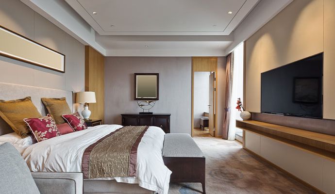 Clean hotel bedroom interior with bed and other furnitures