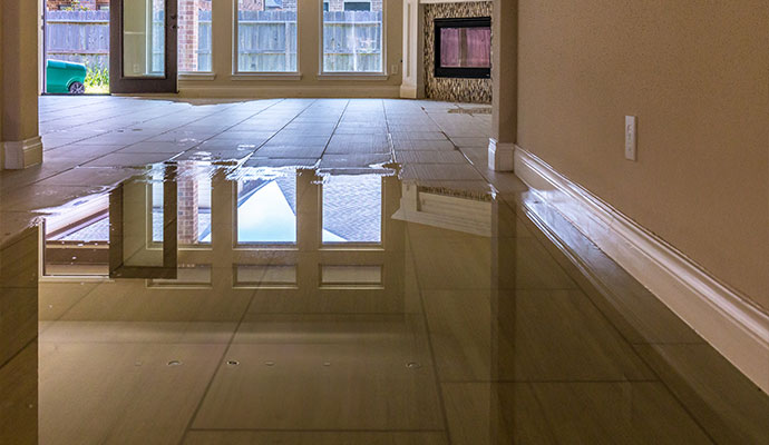 Flooded tile floor with standing water