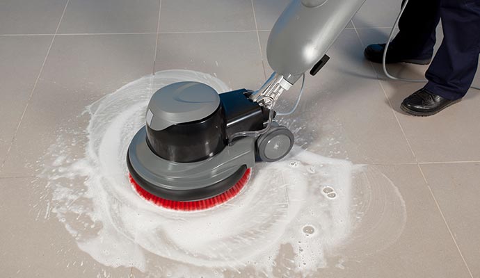 Expert providing professional floor cleaning service using specialized equipment