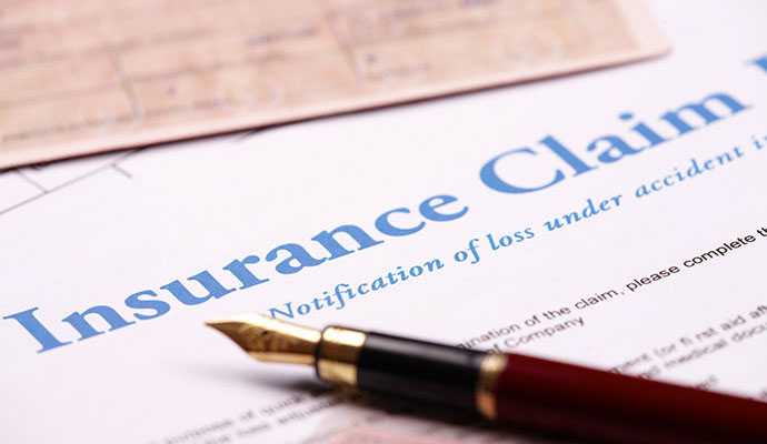 Insurance claim documents with a pen on the table