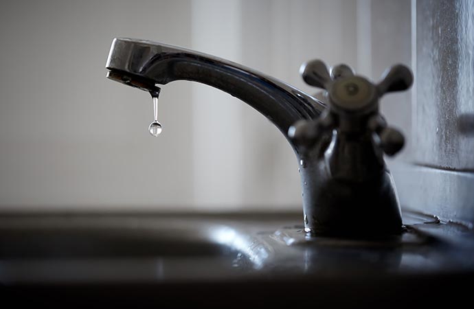 leaky faucet water drop from the tap