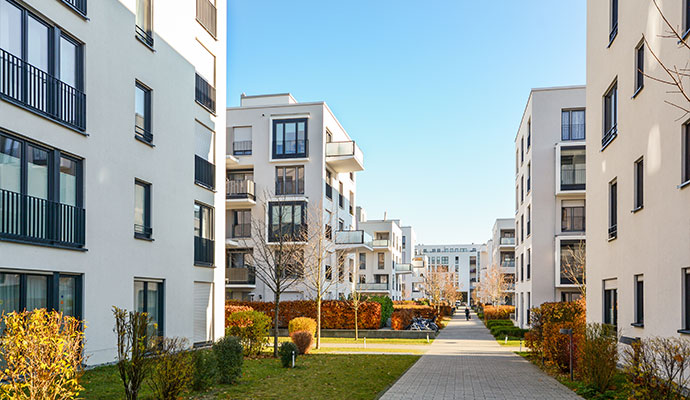 Modern apartment buildings with landscaped courtyard pathway