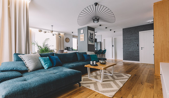 Modern living room with a teal sectional sofa