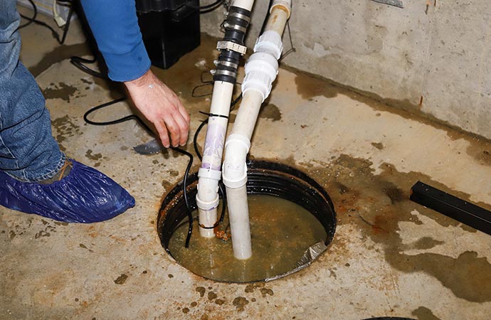 plumber sump pump overflow cleanup flooded basement in a residential home