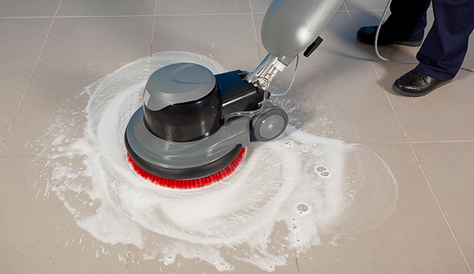 Professional floor scrubber machine cleaning tile floor