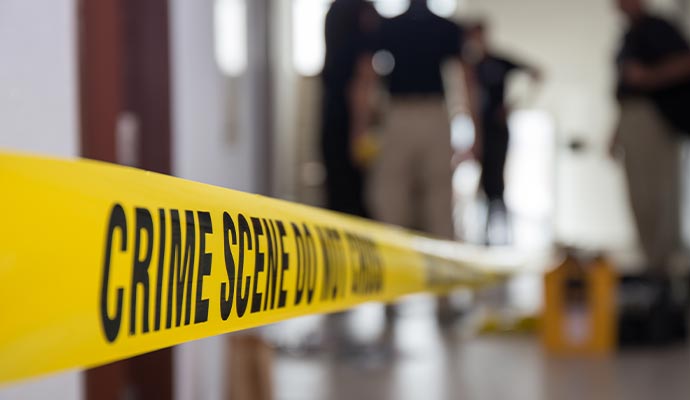 Sealed crime scene secured by police with caution barriers