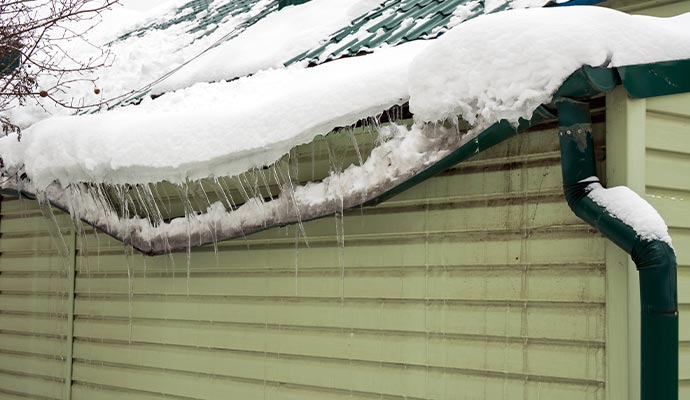 Gutter and downspout blockage due to heavy snow load on roofs