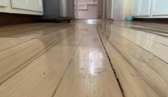 Close-up view of a warped wooden floor