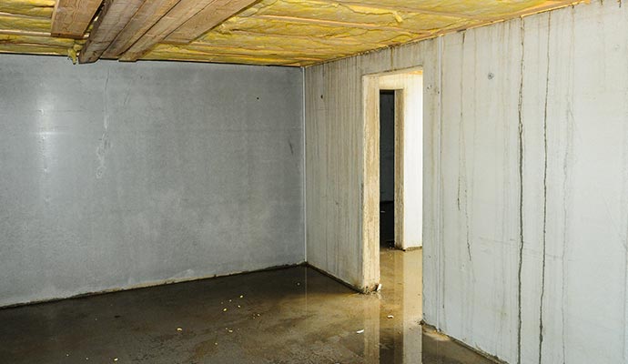 Flooded basement showing water on the floor Residential basement flooded with water on the floor
