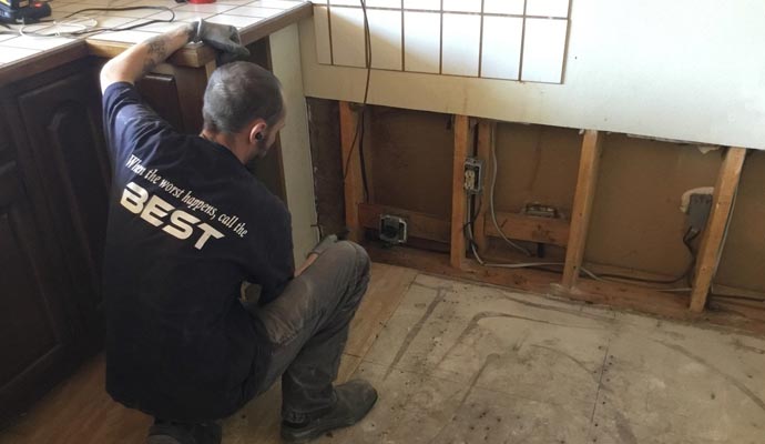 A Best Cleaning and Disaster Restoration Services professional inspecting area