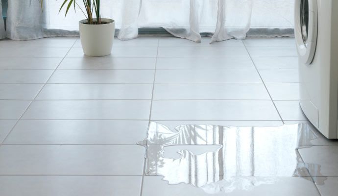 Water on the floor from a leaking washing machine