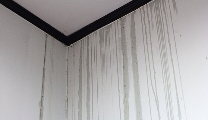 Water streaks and stains on white drywall corner