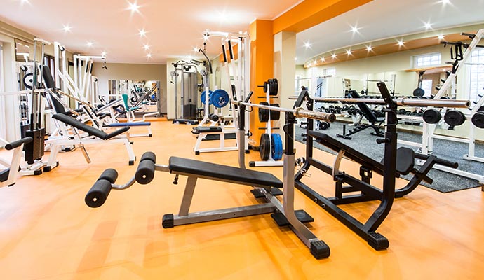 Interior of a well-equipped gym with various exercise machines and equipment