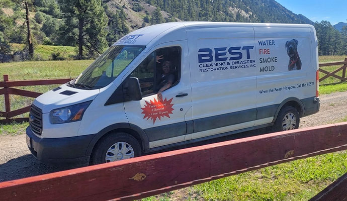 White Best Cleaning service van parked beside a mountain view