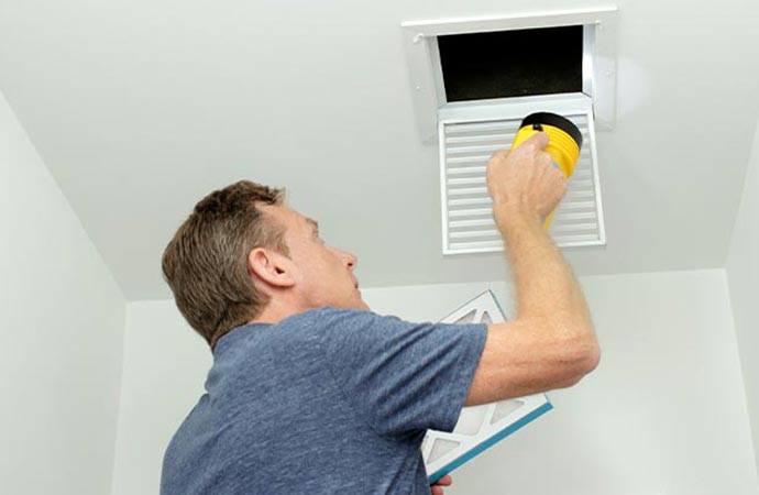 worker inspecting duct